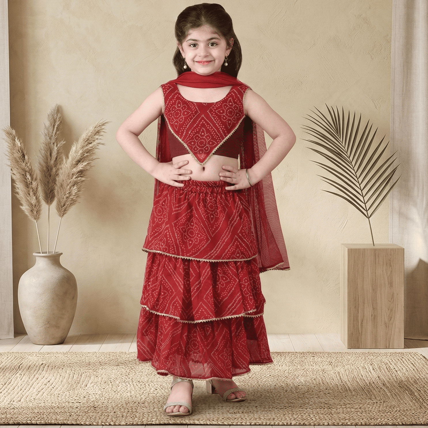 Young girl in a Cute red Ethnic outfit for Diwali and Festive wear standing in a room .